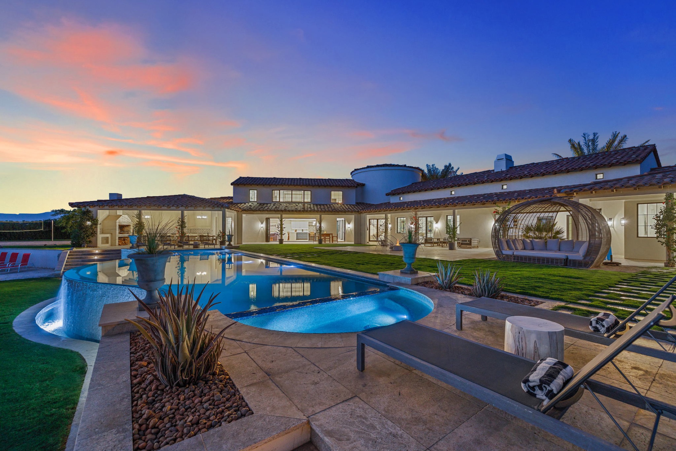 Infinity pool and villa at night